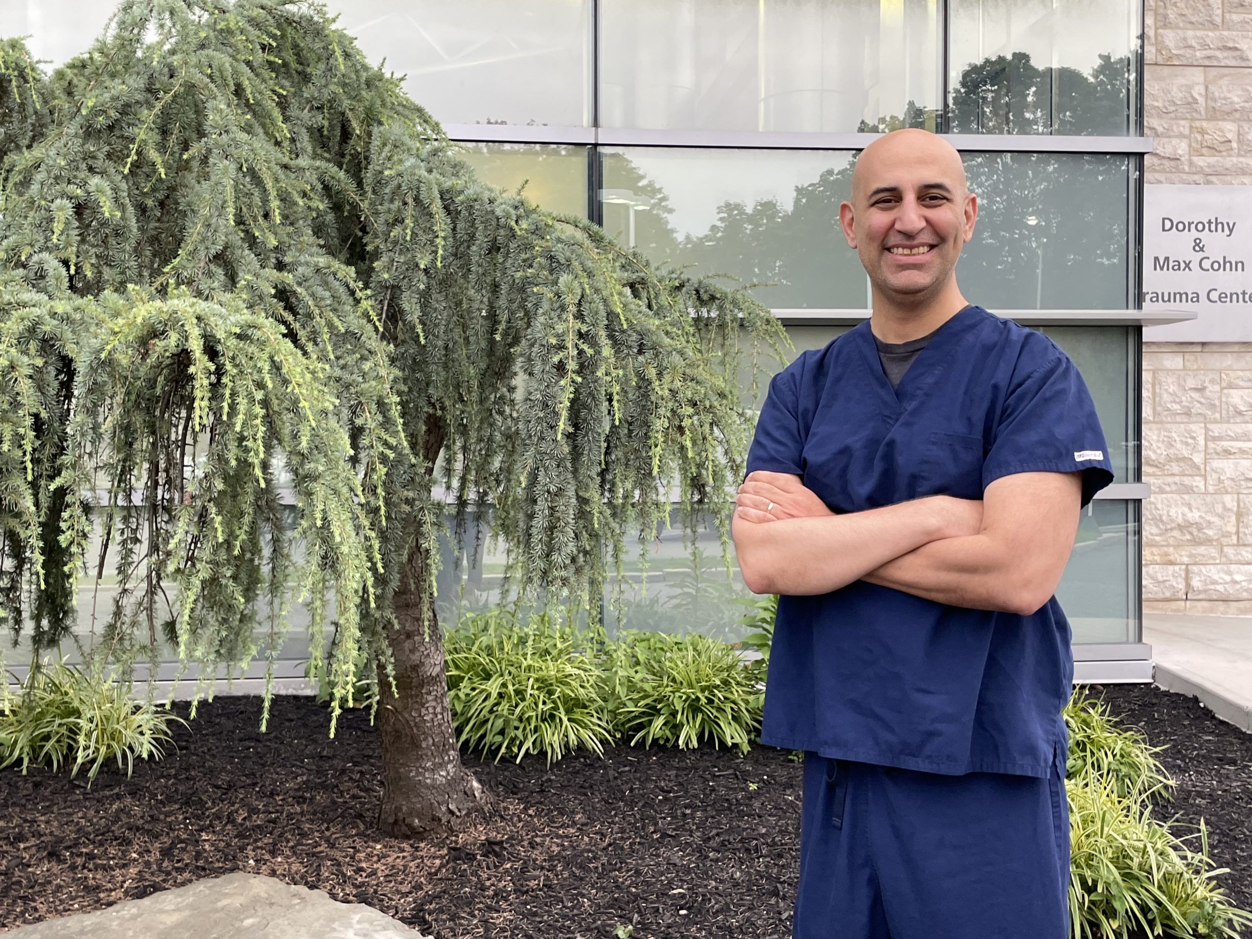 Bora Colak in front of his workplace, Long Island, N.Y., August 2021.